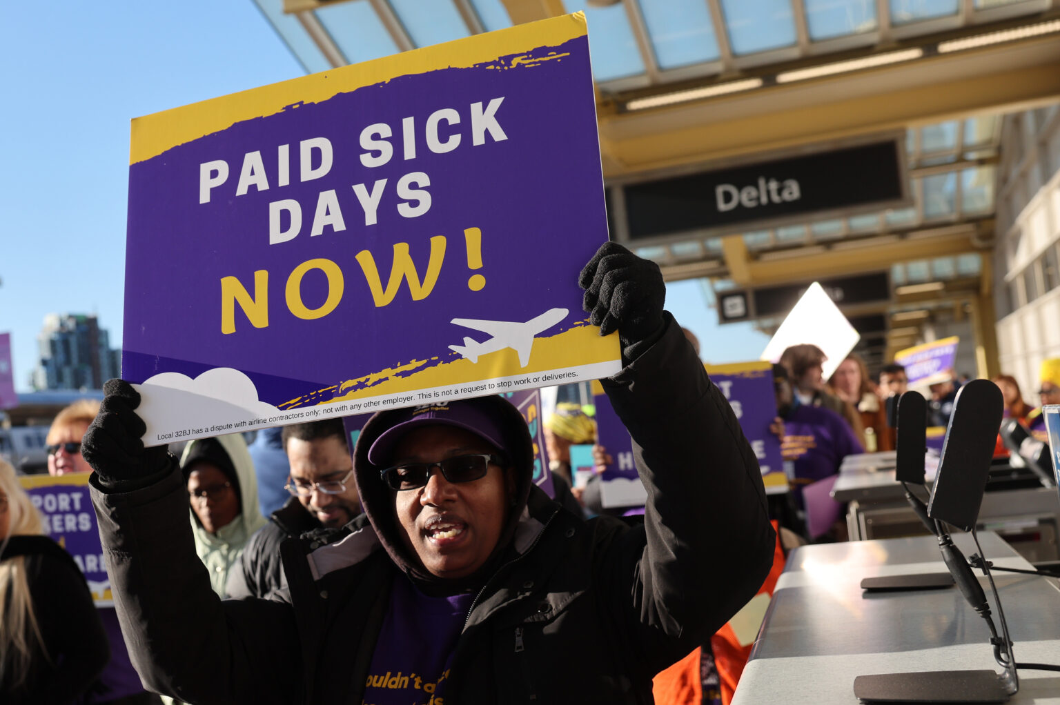 Airport workers and supporters rally for paid sick leave and health care at Reagan National Airport in Virginia. File photo, March 7, 2023.